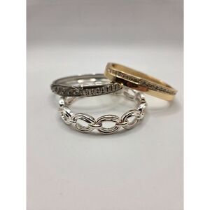 1799. Set of Three Metal Tone Bangle Bracelets